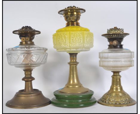 Three 19th/early 20th century brass oil lamps. &nbsp;One has green ceramic base with yellow glass font with two others, one o