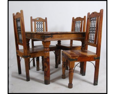 A contemporary Mexican pine dining table and 4 chairs - suite. The table and chairs raised on turned supports with cast metal