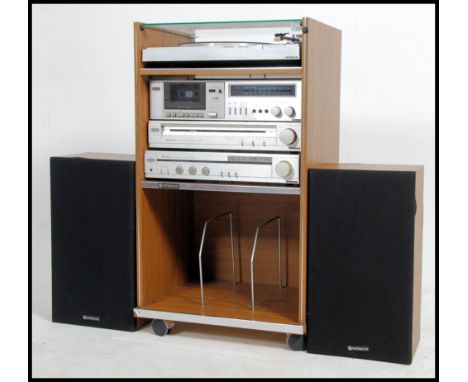 A vintage / retro 1970's stacking system by Hitachi to include amp, tuner, cassette player, record deck in cabinet with speak