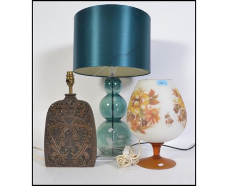 A Tiki ( Polynesian style ) lamp base along with retro lamp in the form of an over sized brandy glass together with double go