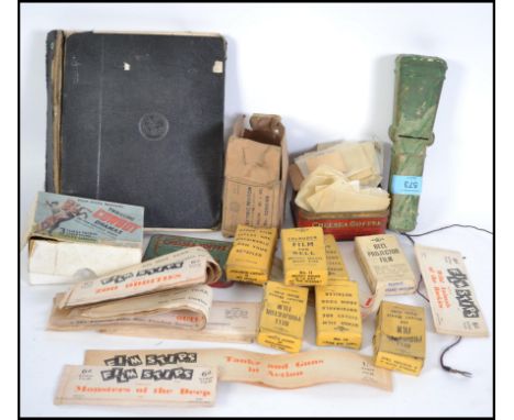 A vintage toy 'Film Stips', 35mm film projector with several film strips to include many unopened with title's such as Night 