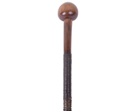 Zulu Knobkerrie, having a oval shaped medium size head with the long wooden shaft being bound in sections of copper band and 