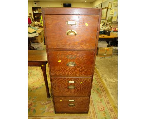 A VINTAGE OAK EFFECT FOUR DRAWER FILING CABINET