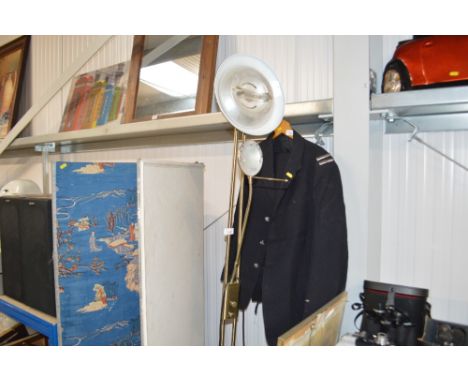 A brass uplighter with reading lamp