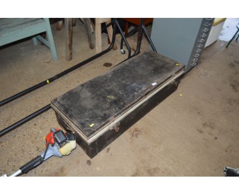 A metal trunk and contents of various books