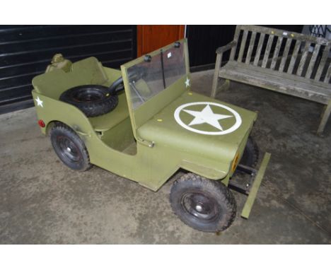 A children's electric powered army style jeep sold as seen