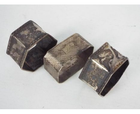 Three silver napkin rings, one with engine turned decoration, Birmingham assay 1956, the others Sheffield assay 1949 / 1950, 