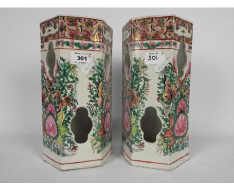 A pair of Chinese ceramic hat stands of hexagonal section, the pierced bodies decorated with flowers and butterflies, zhuansh