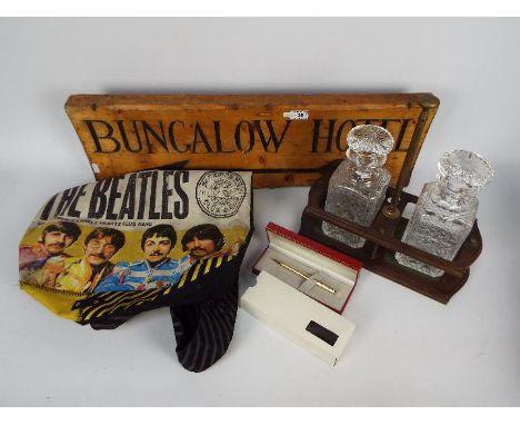 Lot to include a vintage carved wood directional sign 'Bungalow Hotel, two decanters and stand, Sheaffer pen and other. [2]'
