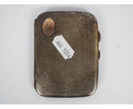 A George V silver cigarette case with engine turned decoration and inset 9ct rose gold initial cartouche, Chester assay 1923,