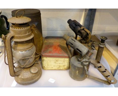 Tray of antique hurricane lamp, blowtorches and camping stoves. 