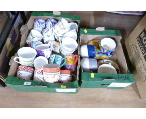 Two boxes of brightly coloured ceramic mugs, Dartmouth Fine China, The Caravan Trail etc