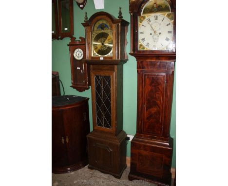 A reproduction Oak cased ''Tempus Fugit'' style Longcase Clock having arch top, over single glazed door between turned column