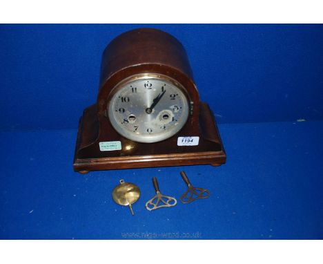 A Napoleon Hat chiming Mantle Clock with two keys, eight day movement, chiming on the half hour.