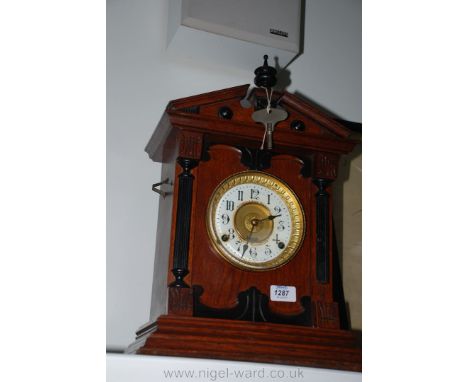 A Mahogany cased, classical style Mantle Clock by Fattorini & Sons, Bradford, with automatic alarm, key and pendulum.