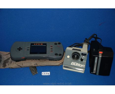 Two instant Cameras and a Lynx Atari hand console.