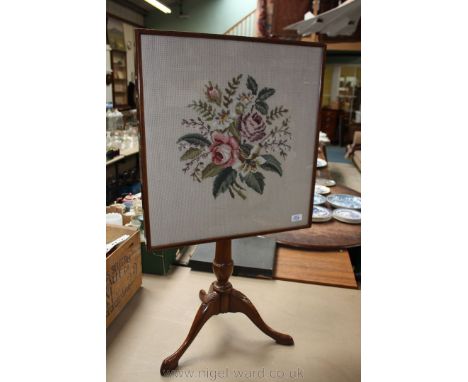 An interesting tilt-top Occasional Table having tapestry under glass, in wooden frame as the top, on turned pedestal base wit