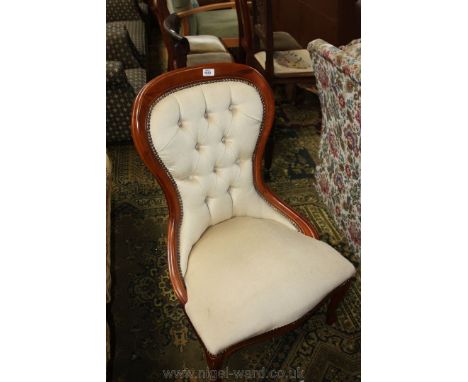 A contemporary reproduction Hotel reception Easy Chair having mahogany show frame hoop button back, standing on stylised cabr