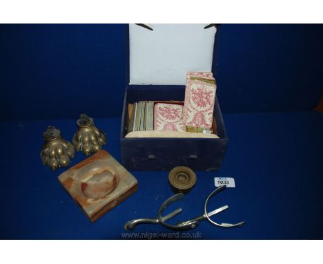 A pair of brass lions paw feet, an Onyx ashtray, a pair of spurs, a set of brass weights, and a box of miscellaneous playing 