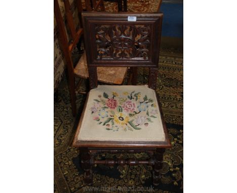 A 19th c. Oak Baronial style Dining/Hall Chair having square form back with fret cut pierced floral carved panel, on carved s