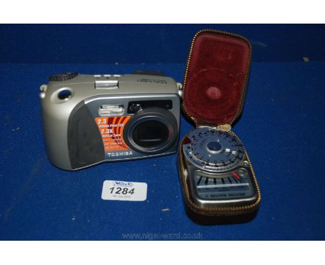 A Toshiba digital still Camera and a Weston light meter.