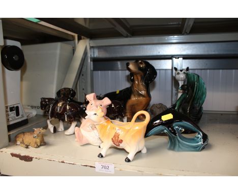 A collection of various ornaments to include Poole Pottery dolphin etc.