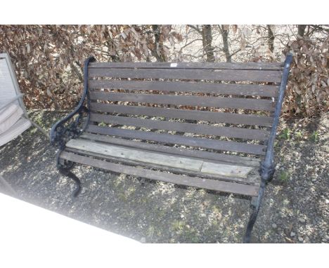 A wooden and cast iron garden bench AF