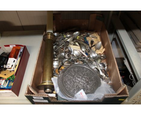 A box containing various silver plated and other cutlery together with a brass candlestick