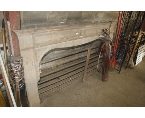 A pine fire surround having labels for Michael Kennedy