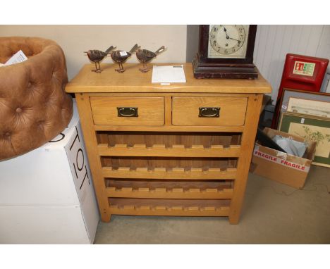 A modern light oak side table fitted two drawers