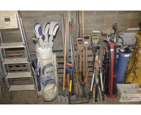 A collection of long handled gardening tools