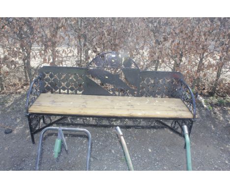 A metal and wooden garden bench decorated with a dolphin