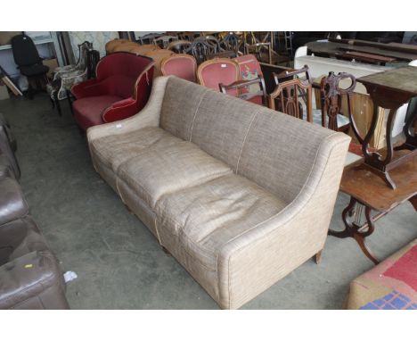 An upholstered three seater sofa