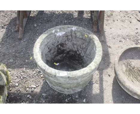 A concrete circular garden planter