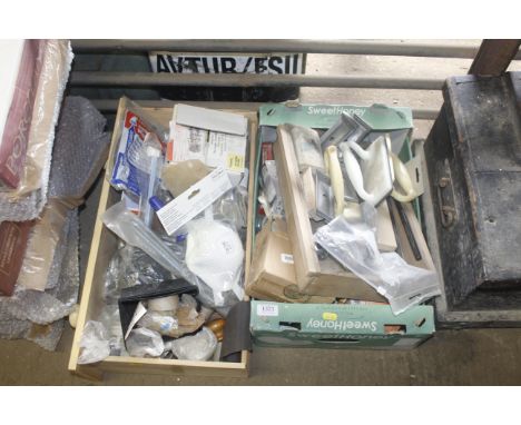 Two boxes containing various light bulbs, face masks, furniture fittings etc 