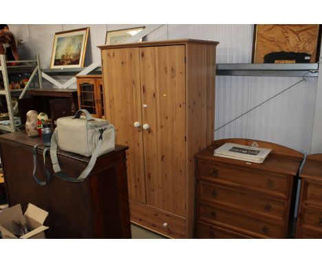 A modern pine two door wardrobe fitted single drawer
