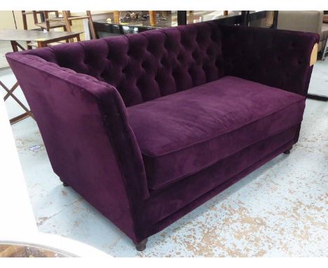 SOFA, with a buttoned back, inner sides and purple upholstery on short turned supports, 154cm L x 79cm H. 