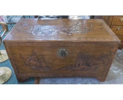 TRUNK, Chinese carved camphorwood depicting traditional scenes with a rising lid, 103cm W x 52cm D x 61cm H. 