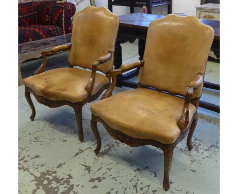FAUTEUILS, a pair, Régence style walnut in light tan leather, 96cm H x 66cm W. (2) (with faults) 