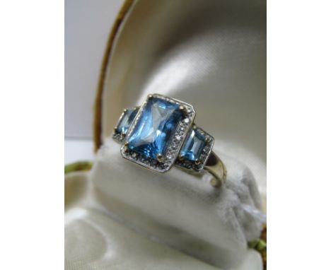 9CT YELLOW GOLD BLUE TOPAZ & DIAMOND COCKTAIL RING, 3 graduating emerald cut blue topaz stones surrounded by ascent brilliant