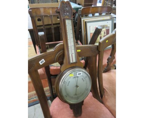 BAROMETER, a carved mahogany cased aneroid barometer with combined thermometer