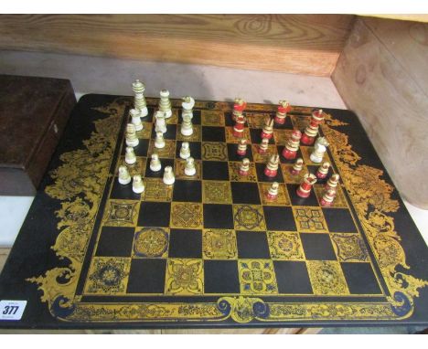 CHESS SET, a gilded and painted wood turned chess set on attractive gilt games board and mahogany storage box