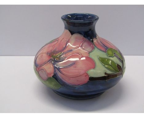 MOORCROFT, a squat form pink magnolia decorated vase on a blue ground