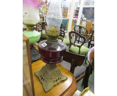 OIL LAMP, Edwardian cast iron base ruby glass reservoir oil lamp