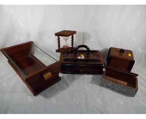 A mahogany inkwell with lower drawer lacking its glass ware, with ebonised features, egg timer, fruit bowl, trinket box and t