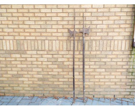 A pair of Halberds, cast metal axe heads with wooden poles, 82cm (length)