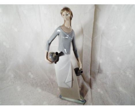 A large Nao figurine depicting a lady holding a water carrier, 40cm (h) Est £20 - £30