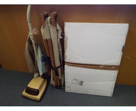 A jigsaw puzzle caddy with four 1000 piece jigsaws, boxed - included in the lot is a vintage vacuum cleaner and camp bed