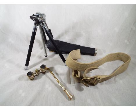 A pair of opera glasses with mother of pearl mounts and handle, a small tripod with case and a military belt with brass buckl