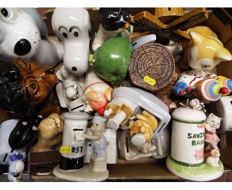 A box containing a collection of novelty ceramic money banks